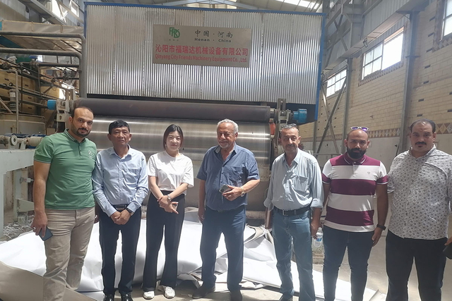 Customer reviewing installation of toilet paper making machine at FRD